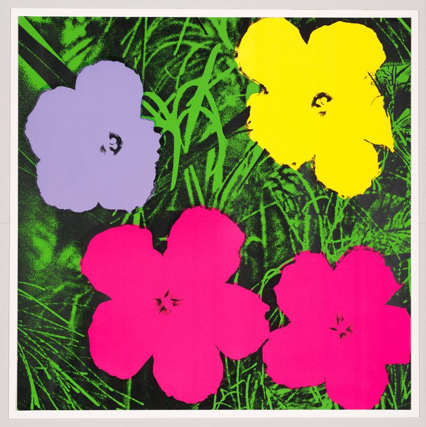 A vibrant pop art style image featuring four large, brightly colored flowers against a green foliage background. The flowers are stylized with flat areas of color: one is purple, one is yellow, and two are pink. The background has a screen-printed texture, suggesting a mix of natural and artificial aesthetics.
