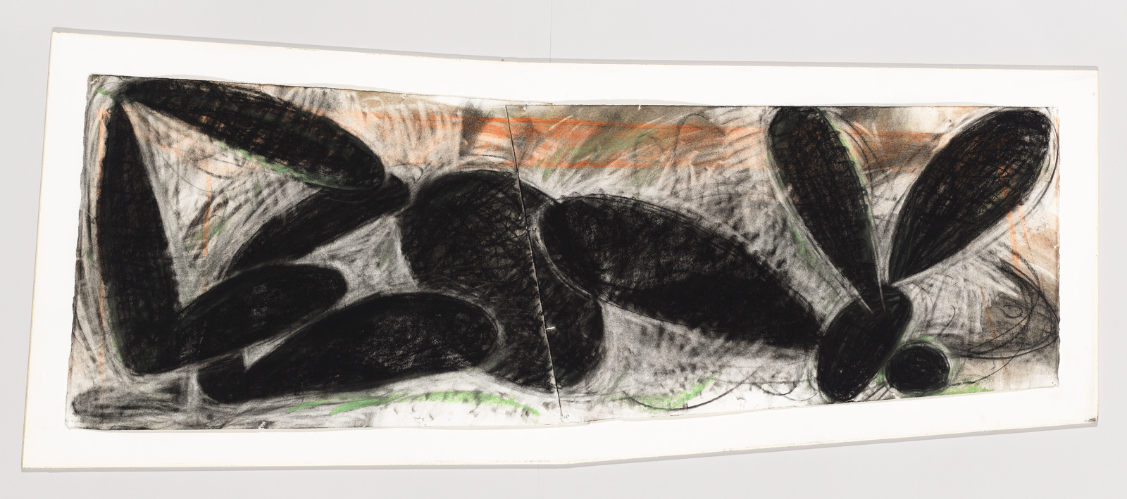 A panoramic abstract artwork featuring bold black shapes that resemble organic forms or stones, with textured charcoal lines and hints of green and orange on a white background, all encased in a simple frame.