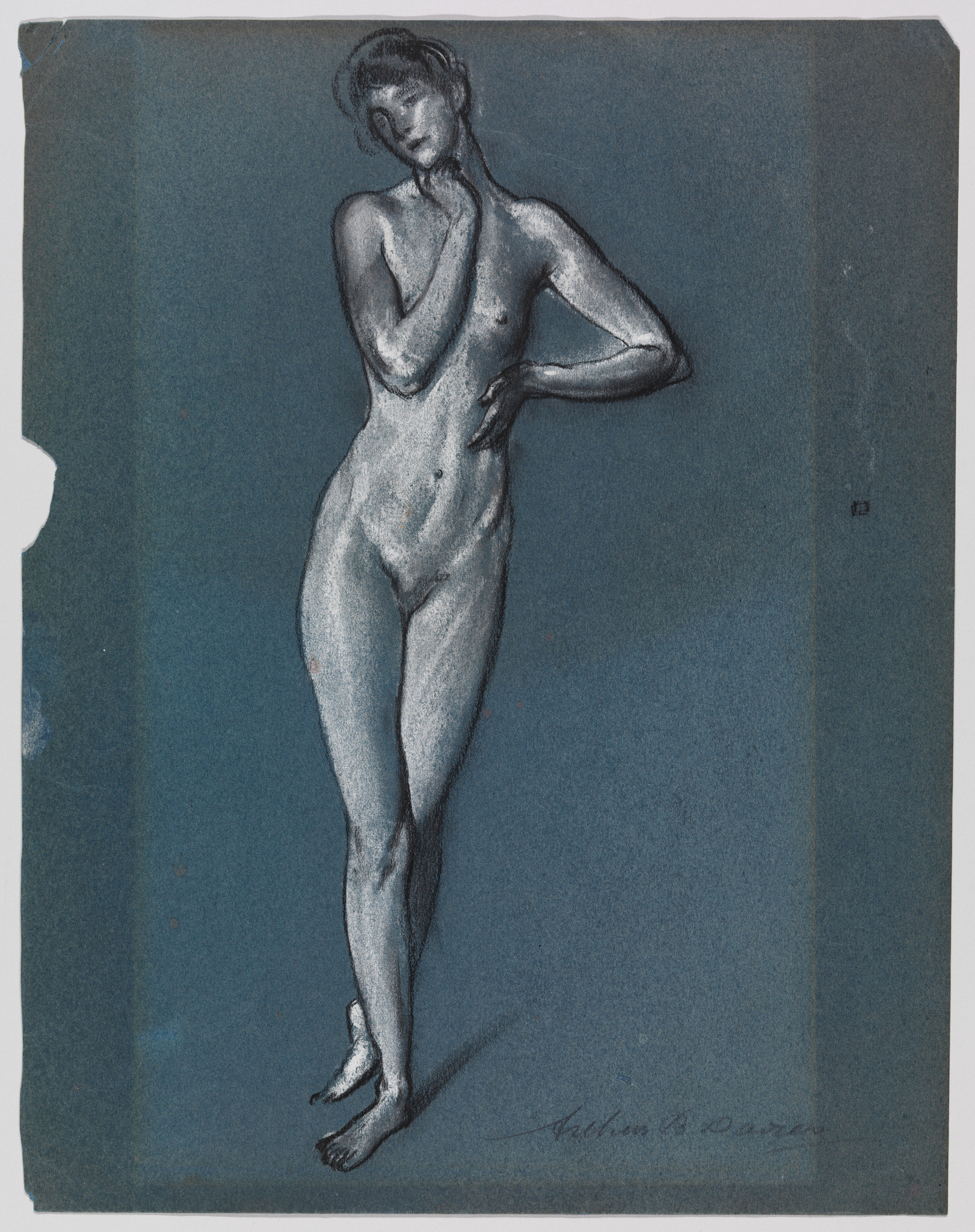 A sketch of a standing female figure on blue paper, depicted in a contrapposto pose with her left hand resting on her thigh and her right hand touching her neck. The figure is rendered with white highlights and dark shading to accentuate the form, and there is a signature at the bottom right corner. The edges of the paper are slightly worn.