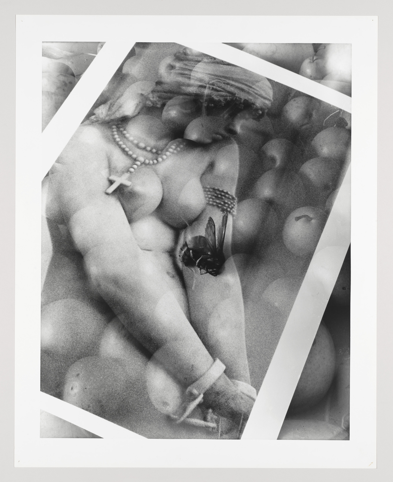 Black and white collage of a nude figure with fruit and a butterfly overlay, framed by angled white borders.