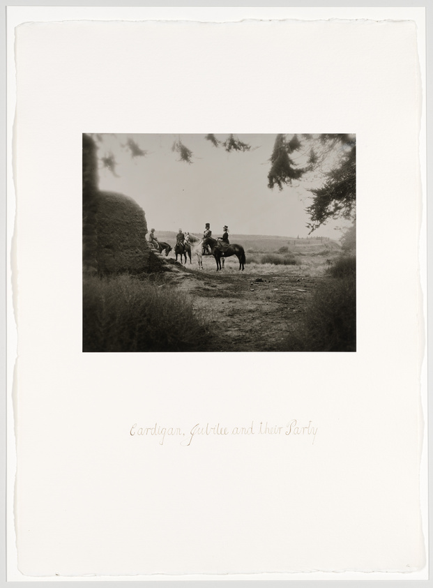 A vintage black and white photograph depicting a group of four horseback riders on a trail, with trees framing the top of the image and handwritten text at the bottom reading "Cardigan, Jubilee and their Party." The photo has a white border with rough edges, suggesting an old print.