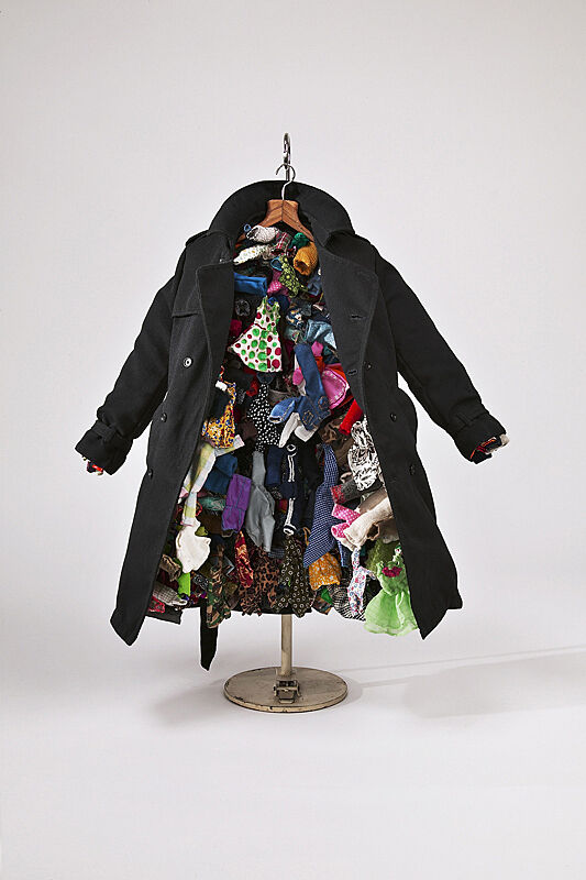 A blue jacket filled with small, colorful dresses.