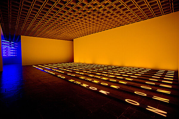 Projected text through lights on a gallery floor.