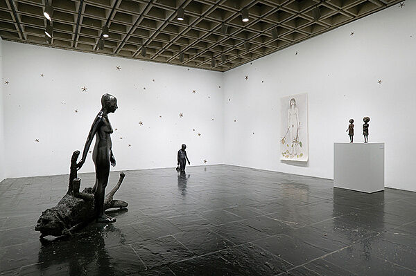 Sculptures and a painting in a gallery.