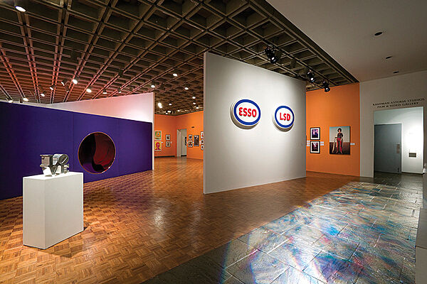 Installation view of Love sculpture and signs on wall.