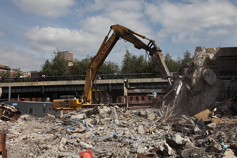Large bulldozer moving rubble.