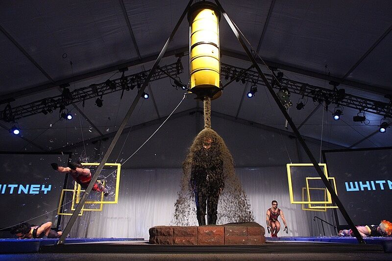 Figures in various states on a lit stage.