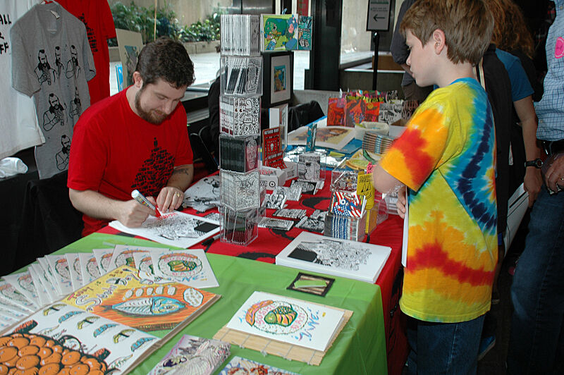 Artist Noah Lyon drawing on comic.