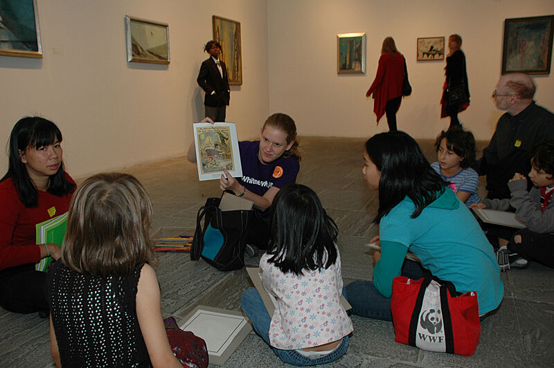 Children sit around and look at a comic.