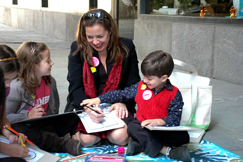 Family smile and help each other draw.
