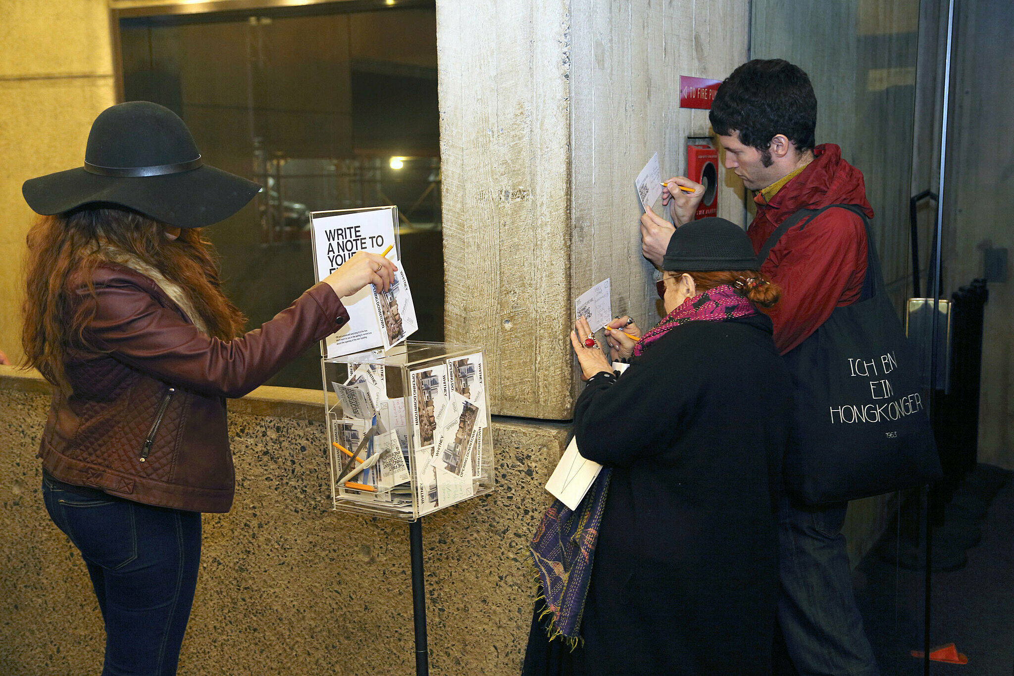 Visitors write on notecards.