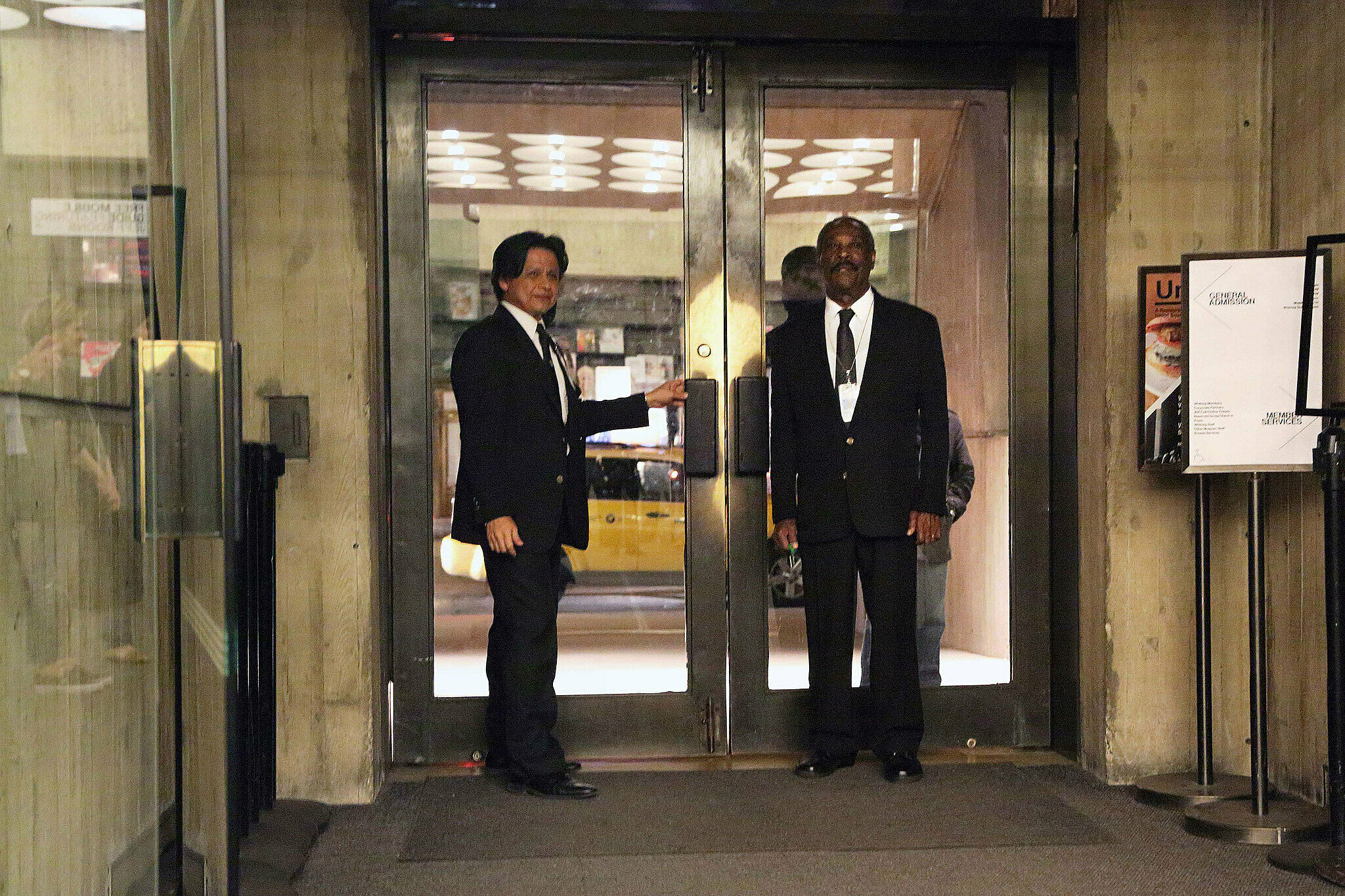 Guards stand by the doors of the museum.