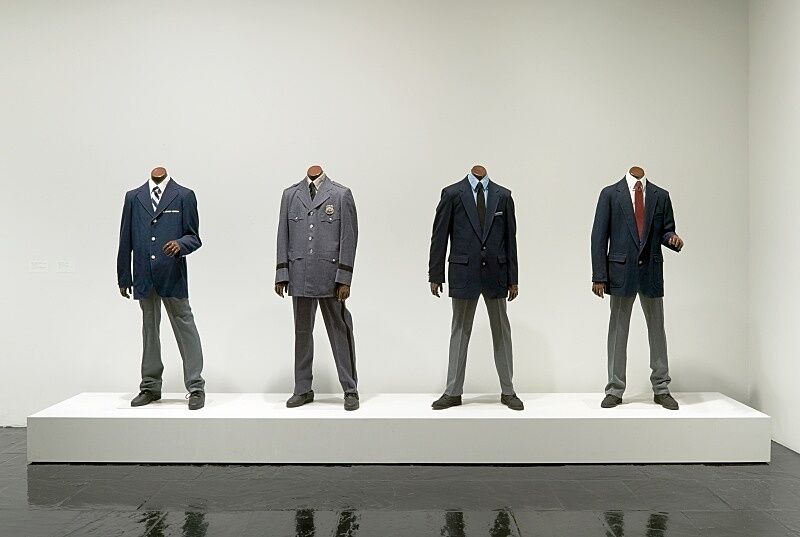 Four models in suits.