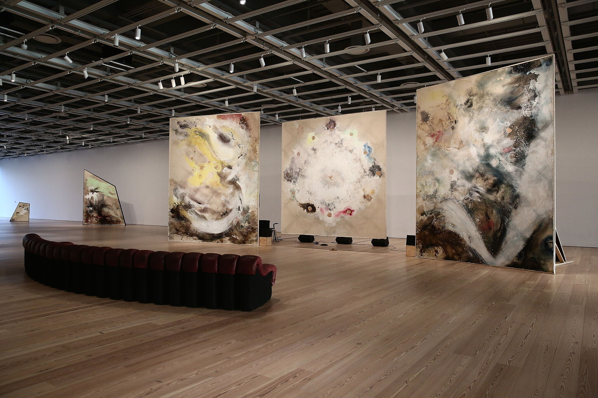 Paintings and couches form a lounge in Lucy Dodd's installation.