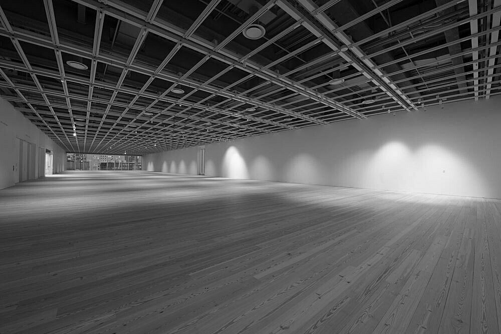 A view of the empty fifth floor Whitney galleries in black and white.
