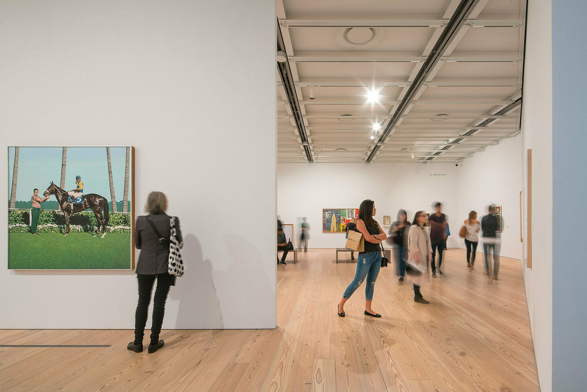 The Whitney Museum galleries populated with people at sunset