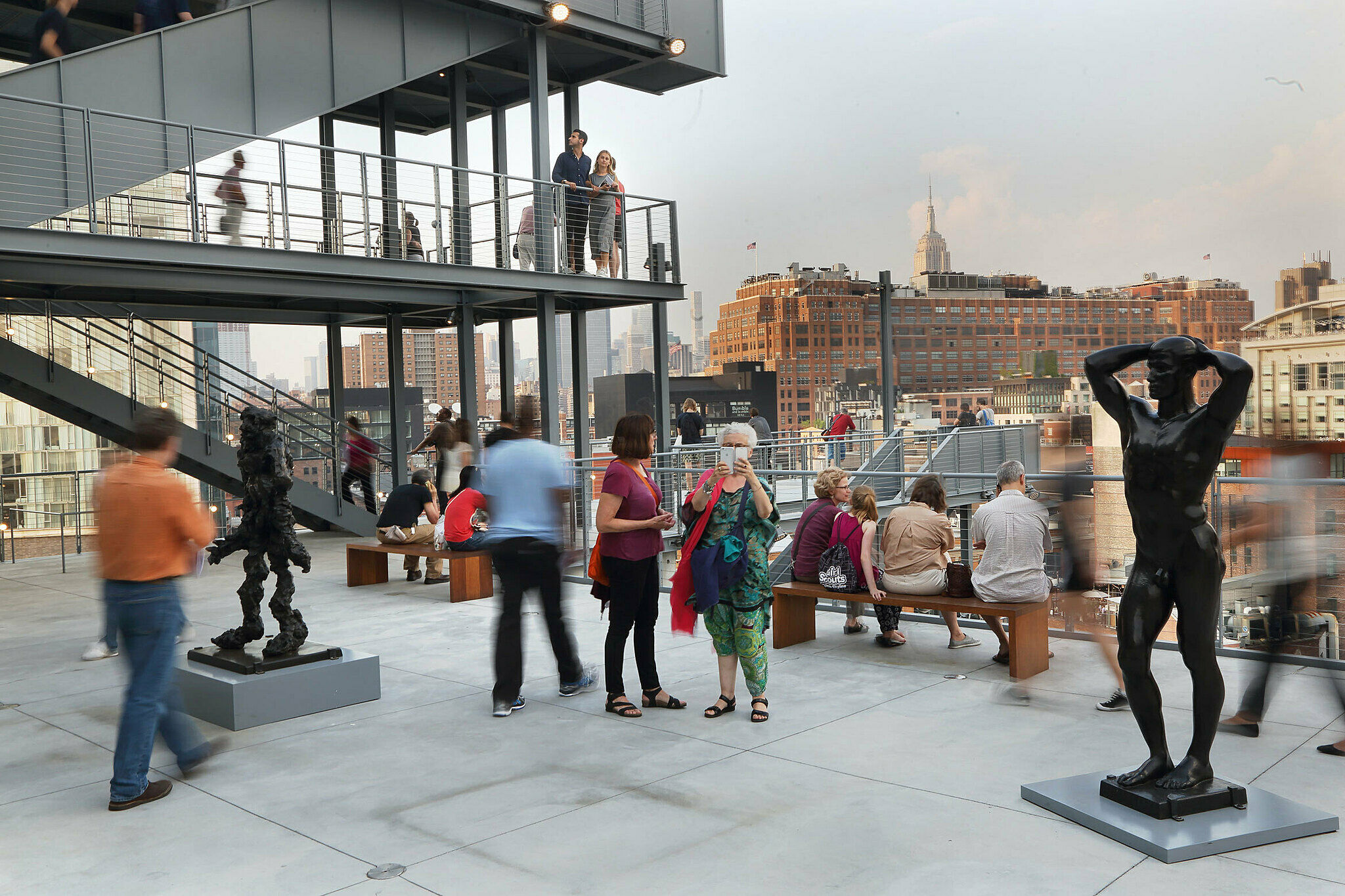 The Whitney Museum galleries populated with people at night