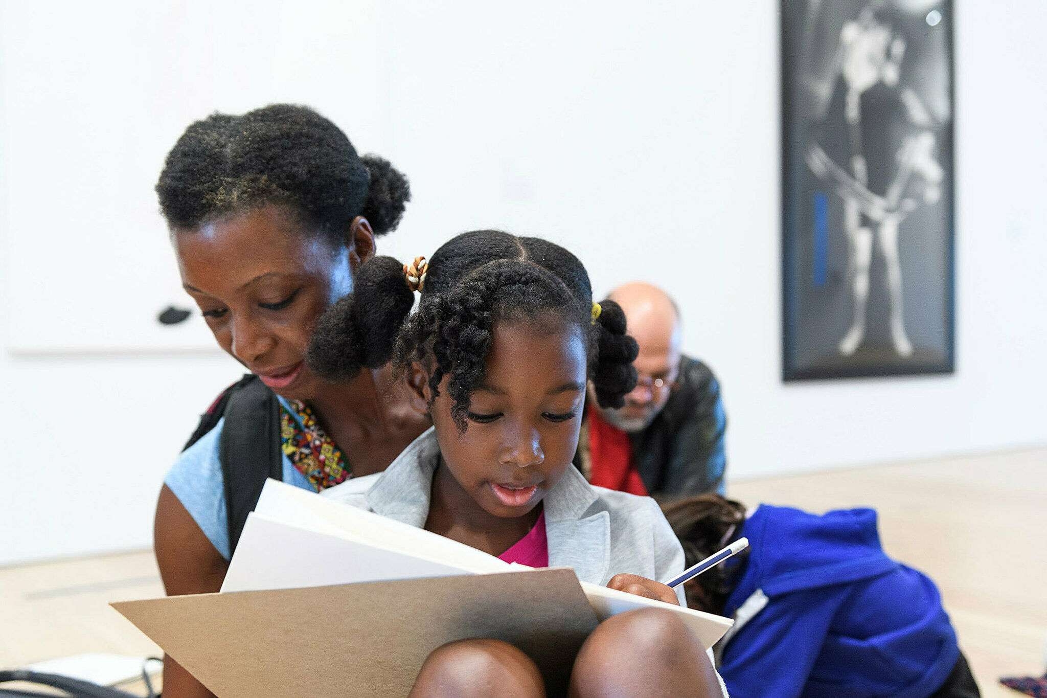 Families sketch together in the galleries