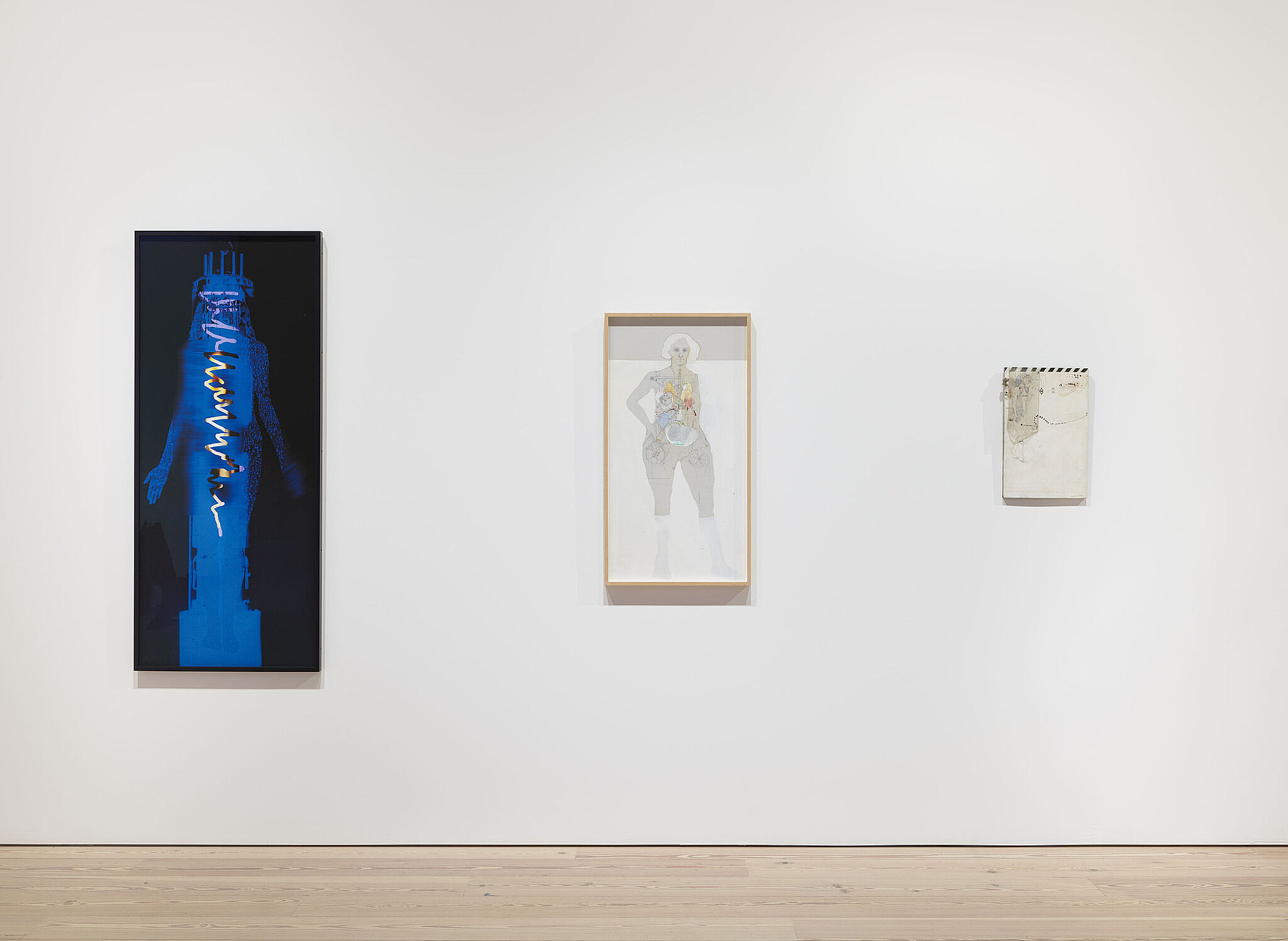 Three artworks on a white gallery wall.