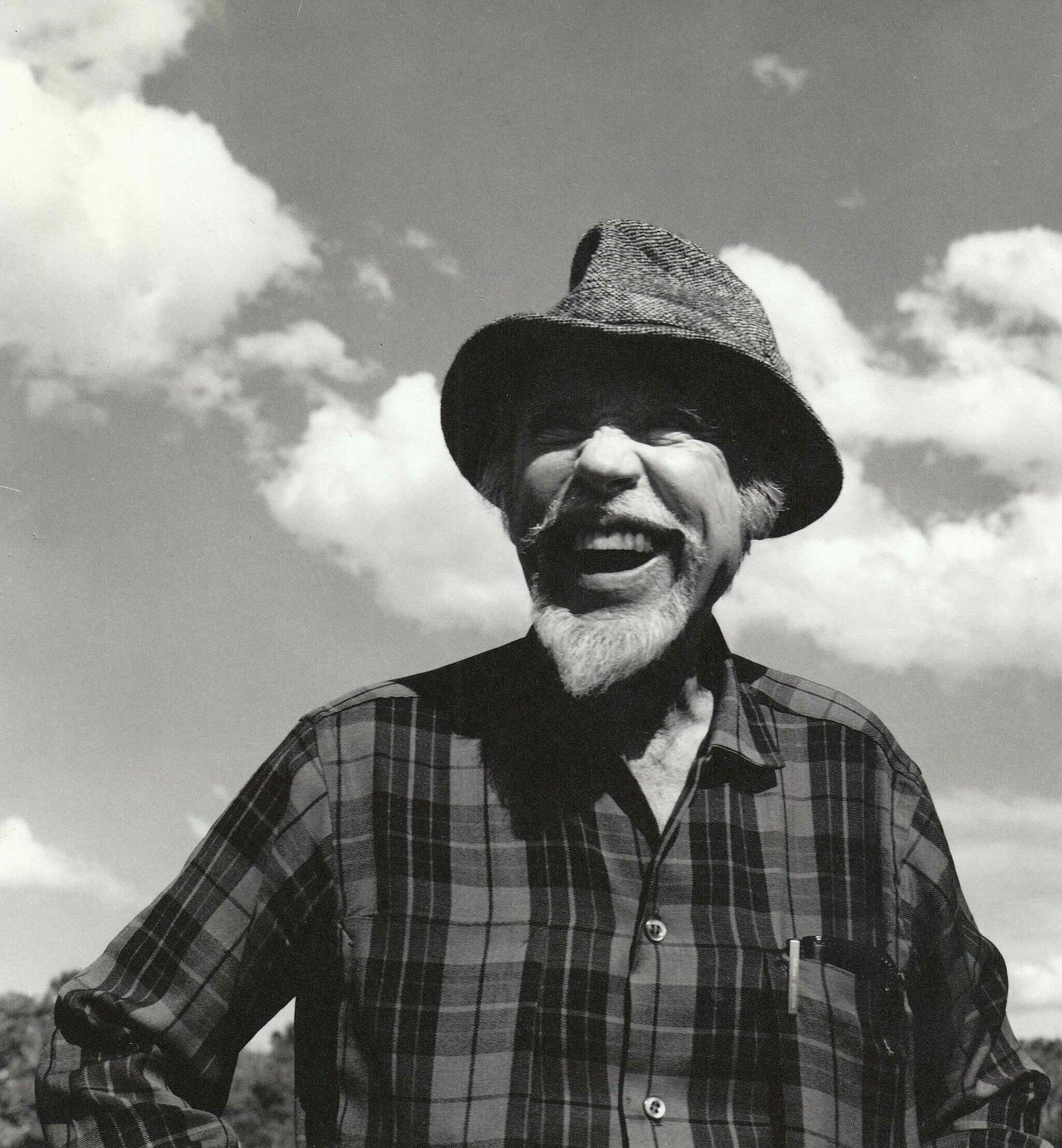 The composer Conlon Nancarrow  smiles with a hat on.