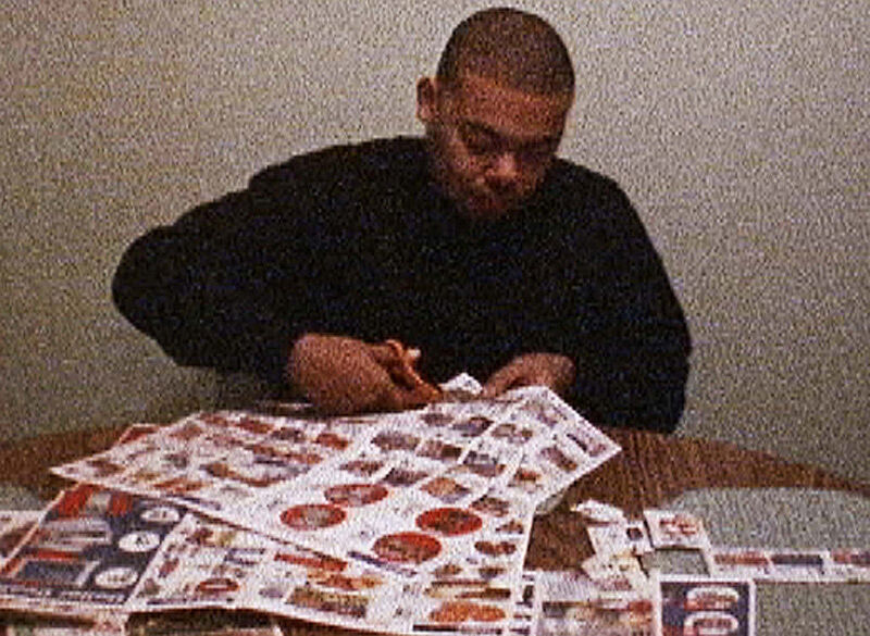 Man cutting through coupons.