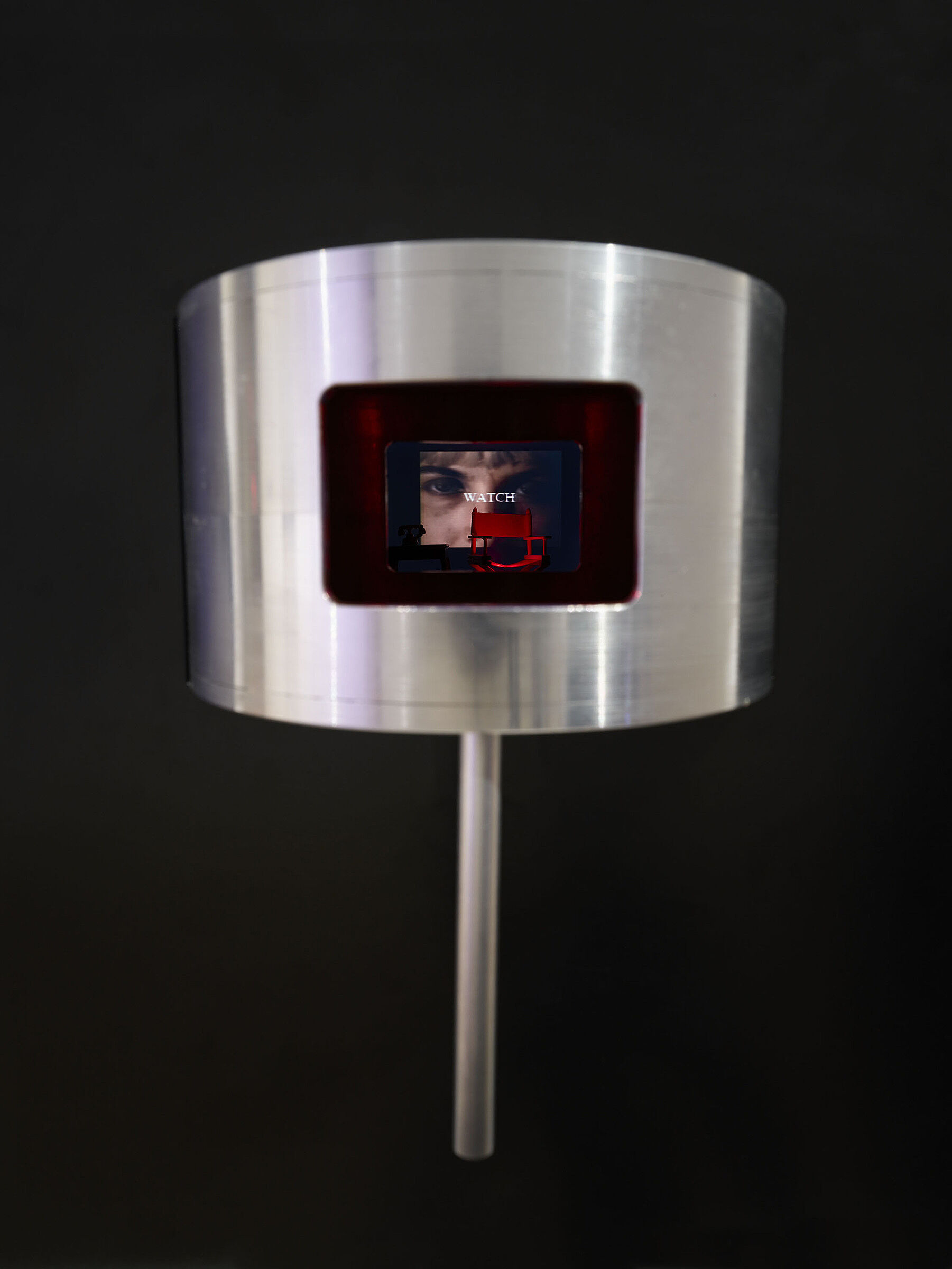 A tiny video screen inside a round silver object.