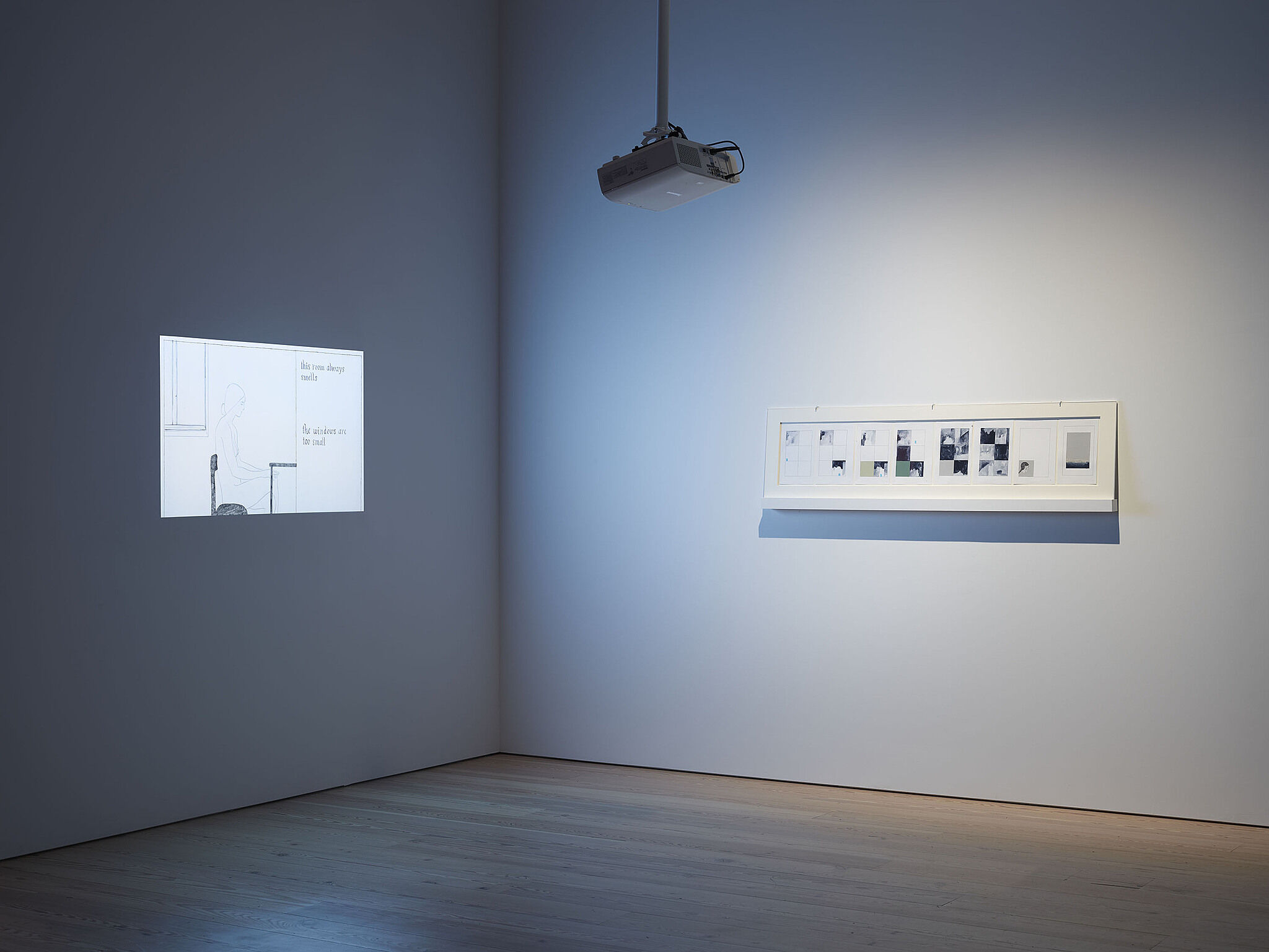 An artwork and video projection on the walls of a gallery.