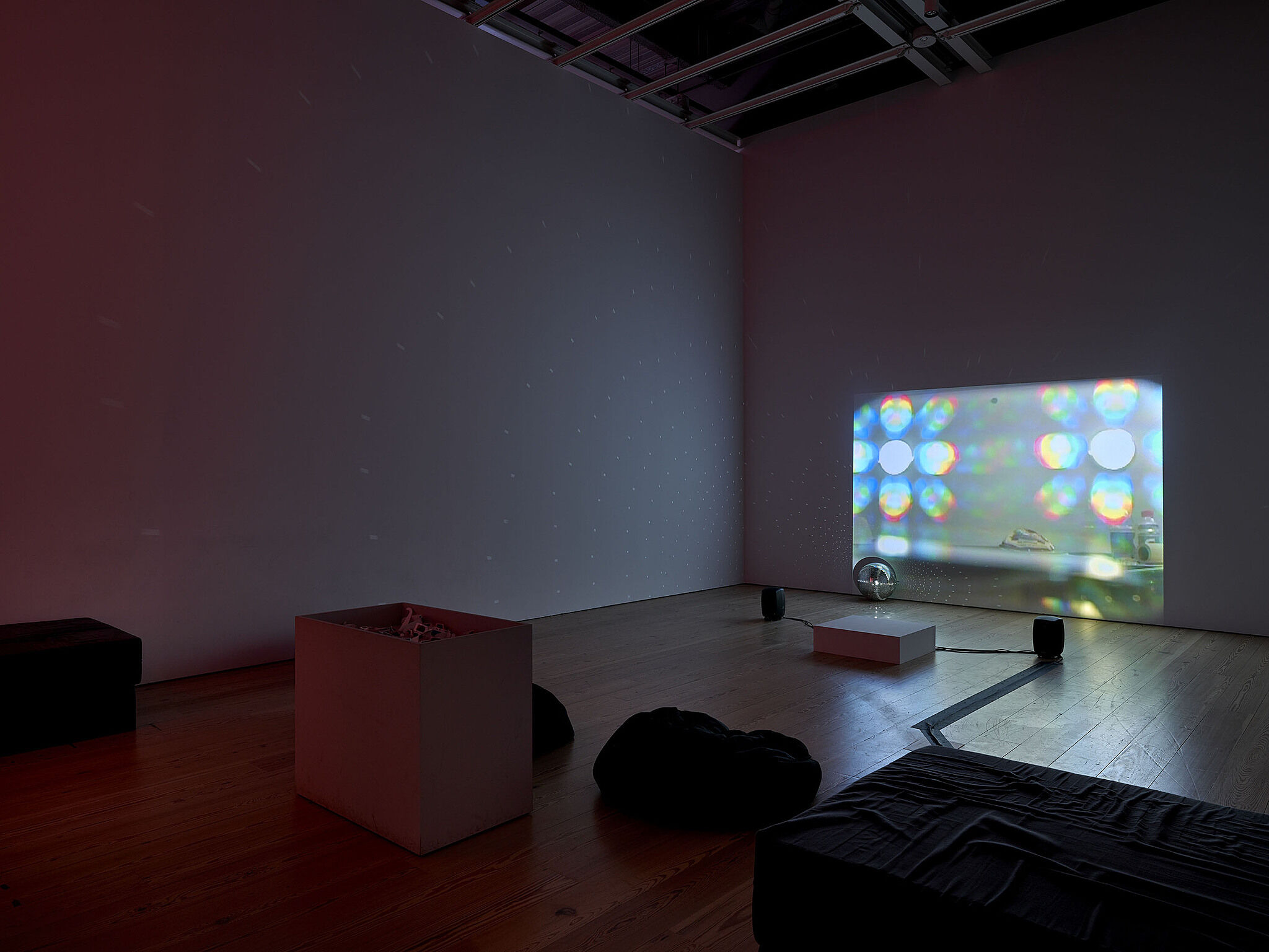 A video installation with a screen showing bright shapes of light.