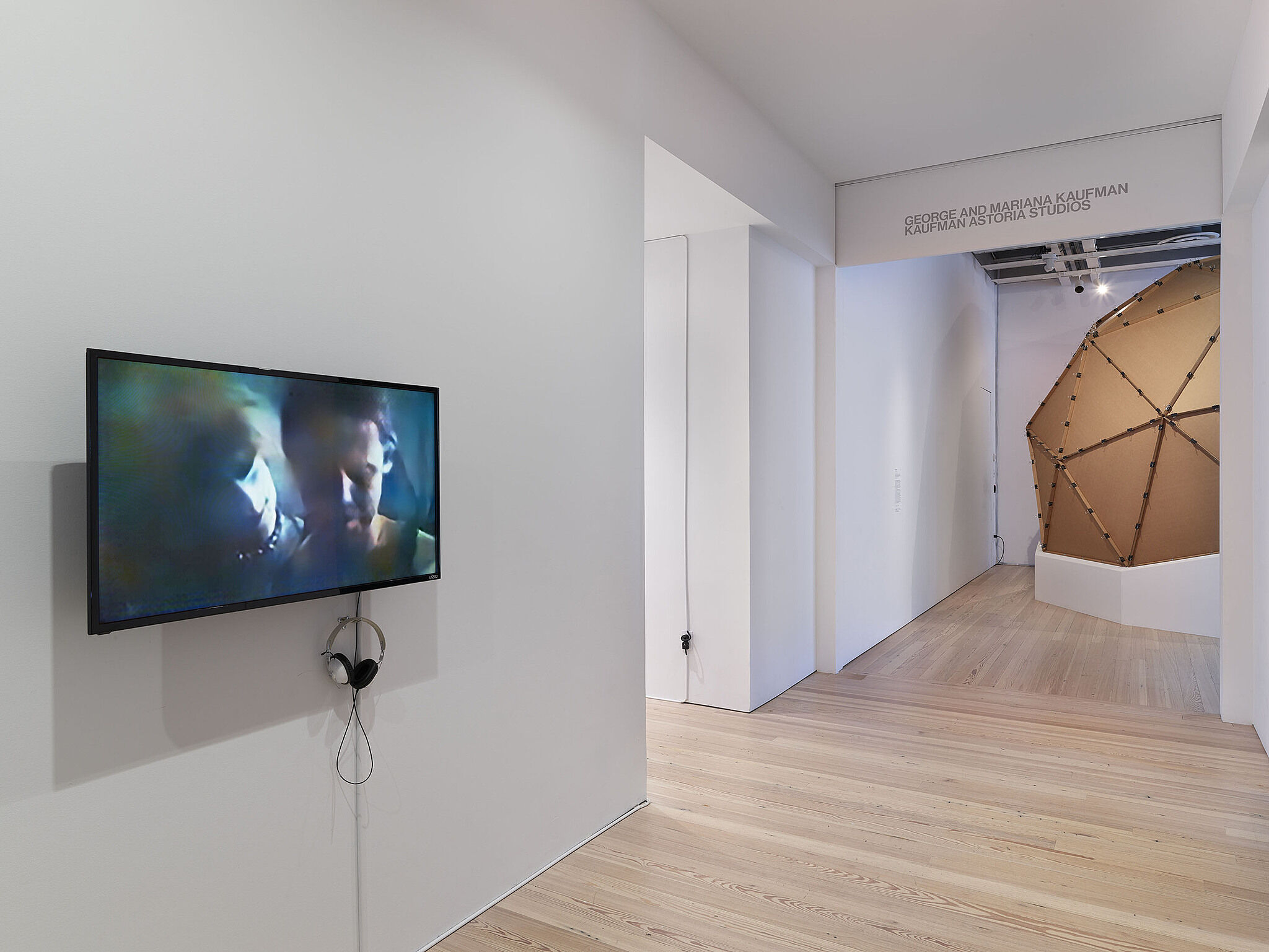 A video installation with a flat screen television showing two faces.