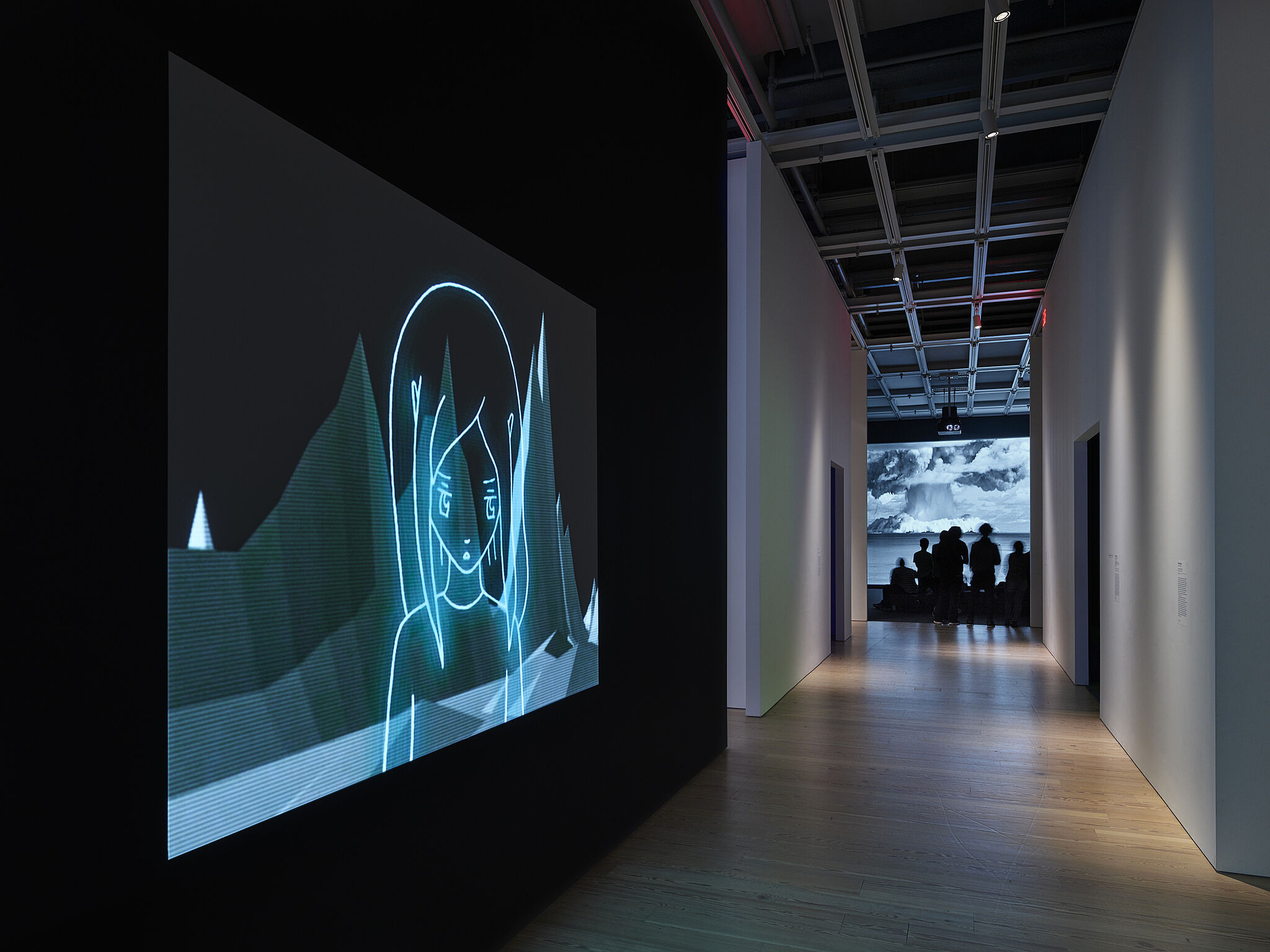 A large video screen displaying an animated drawing of a child.