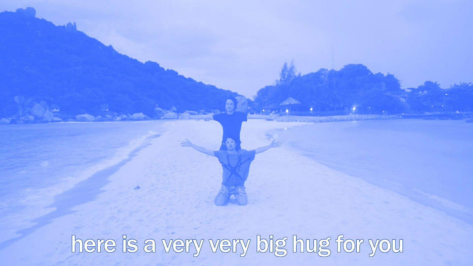 Two persons opening their arms on a beach. 