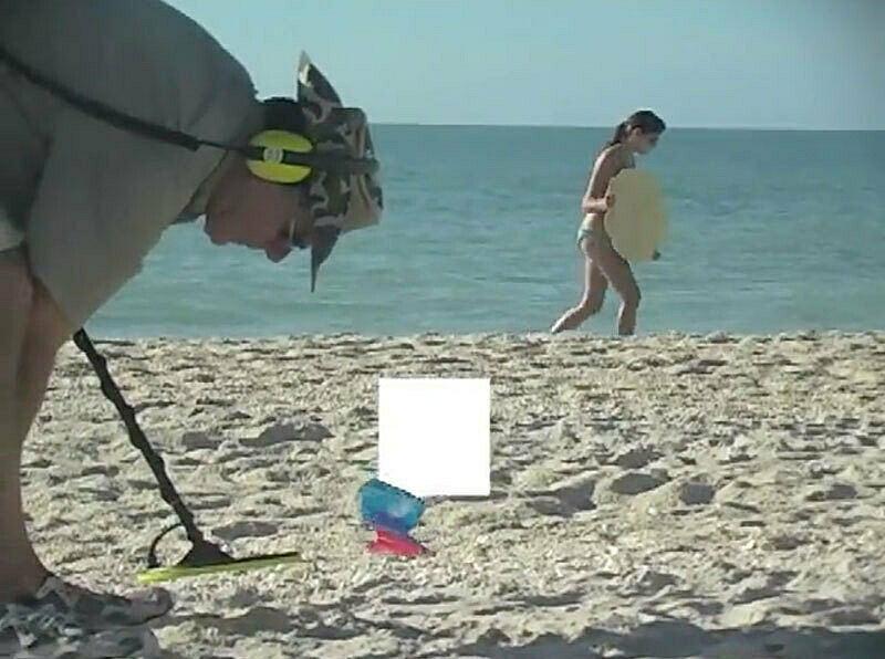 Man bending over a beach.