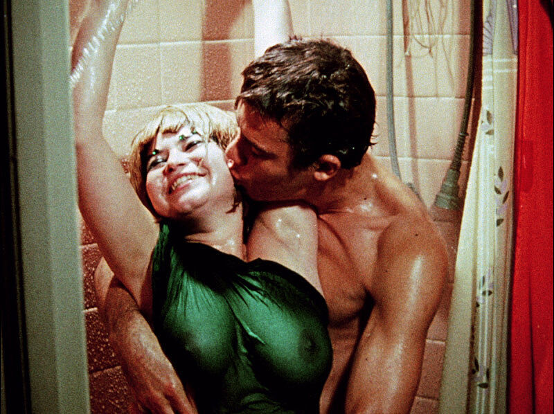 Woman in a dress with a man in the shower.