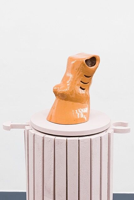 Sculpture on pink column.