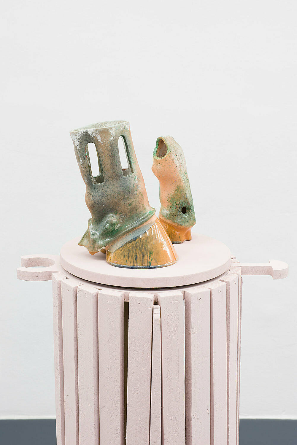 Sculpture on pink column.