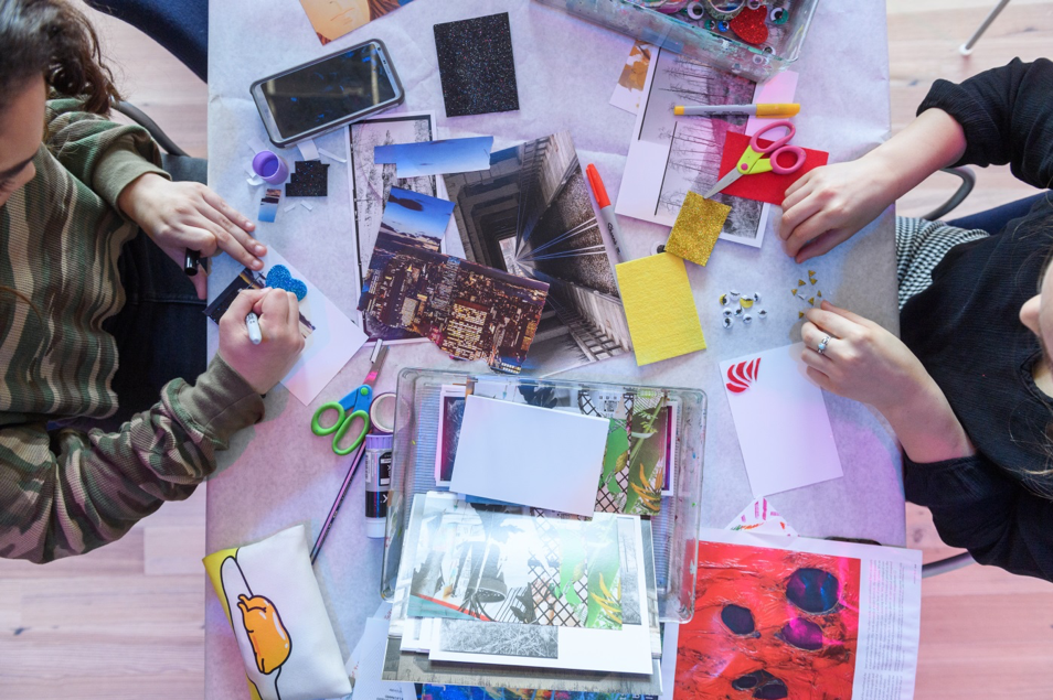 Teens participating in a postcard-making activity.
