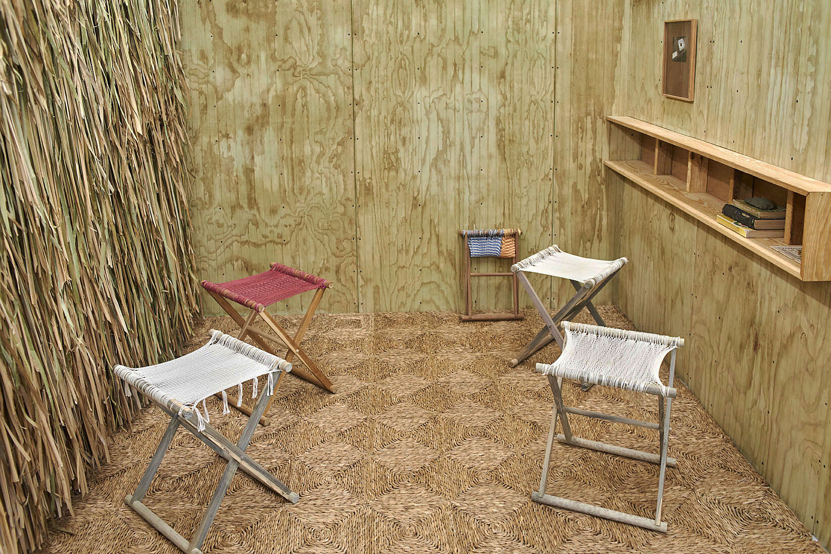 Room with thatched walls and chairs.