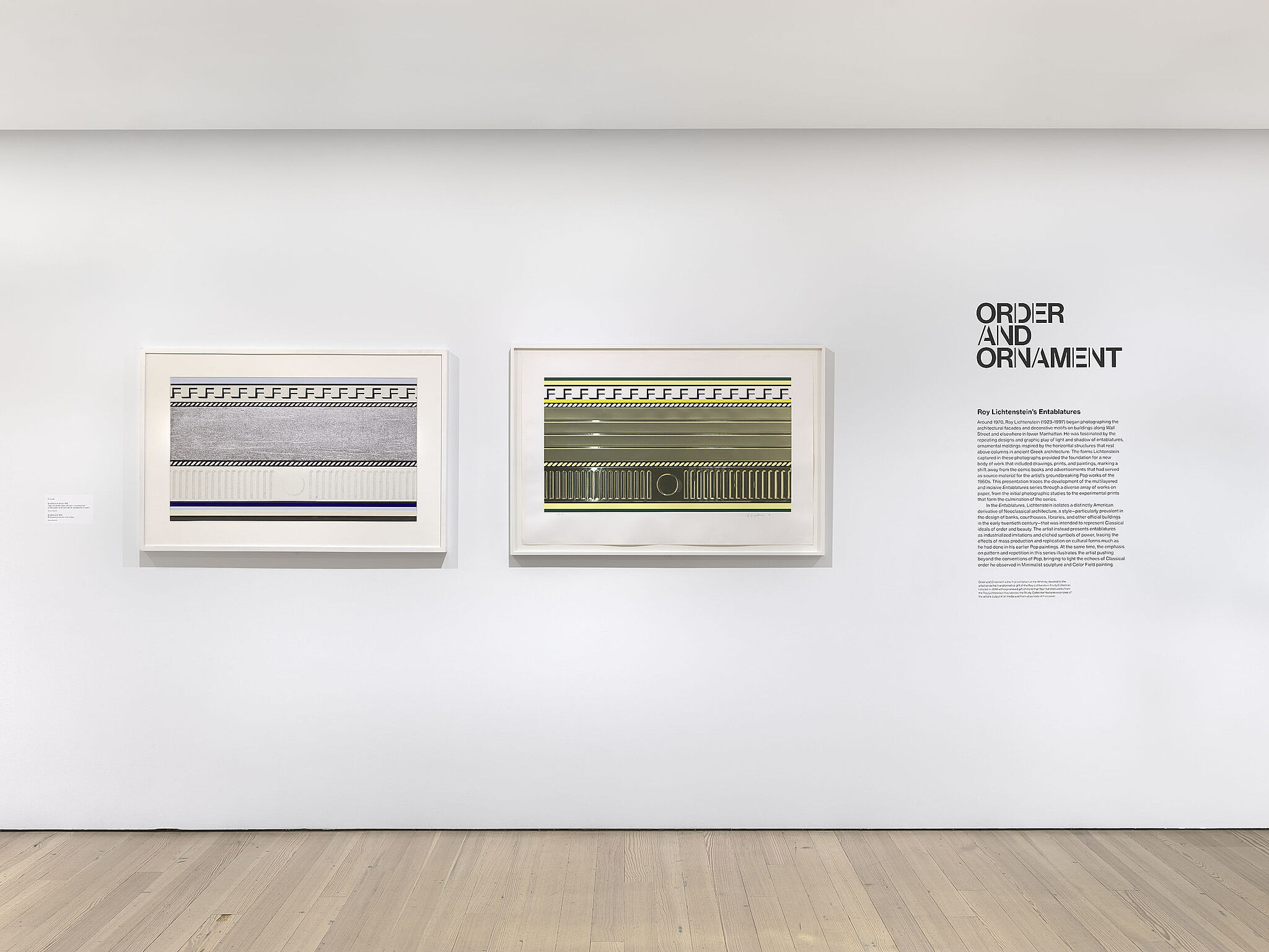 A photo of a Whitney gallery with various artworks and wall text.