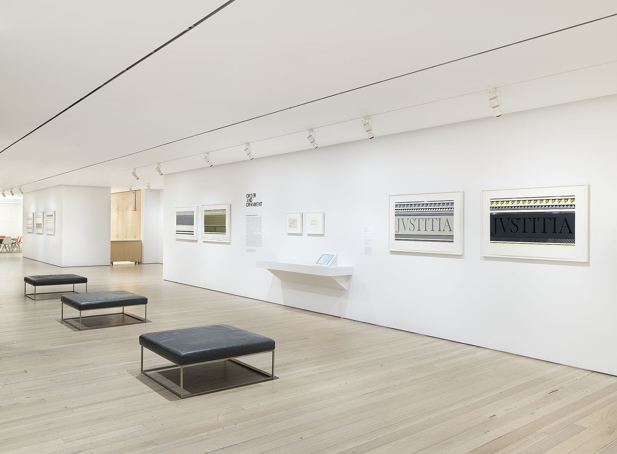 A photo of a Whitney gallery with various artworks on the wall.
