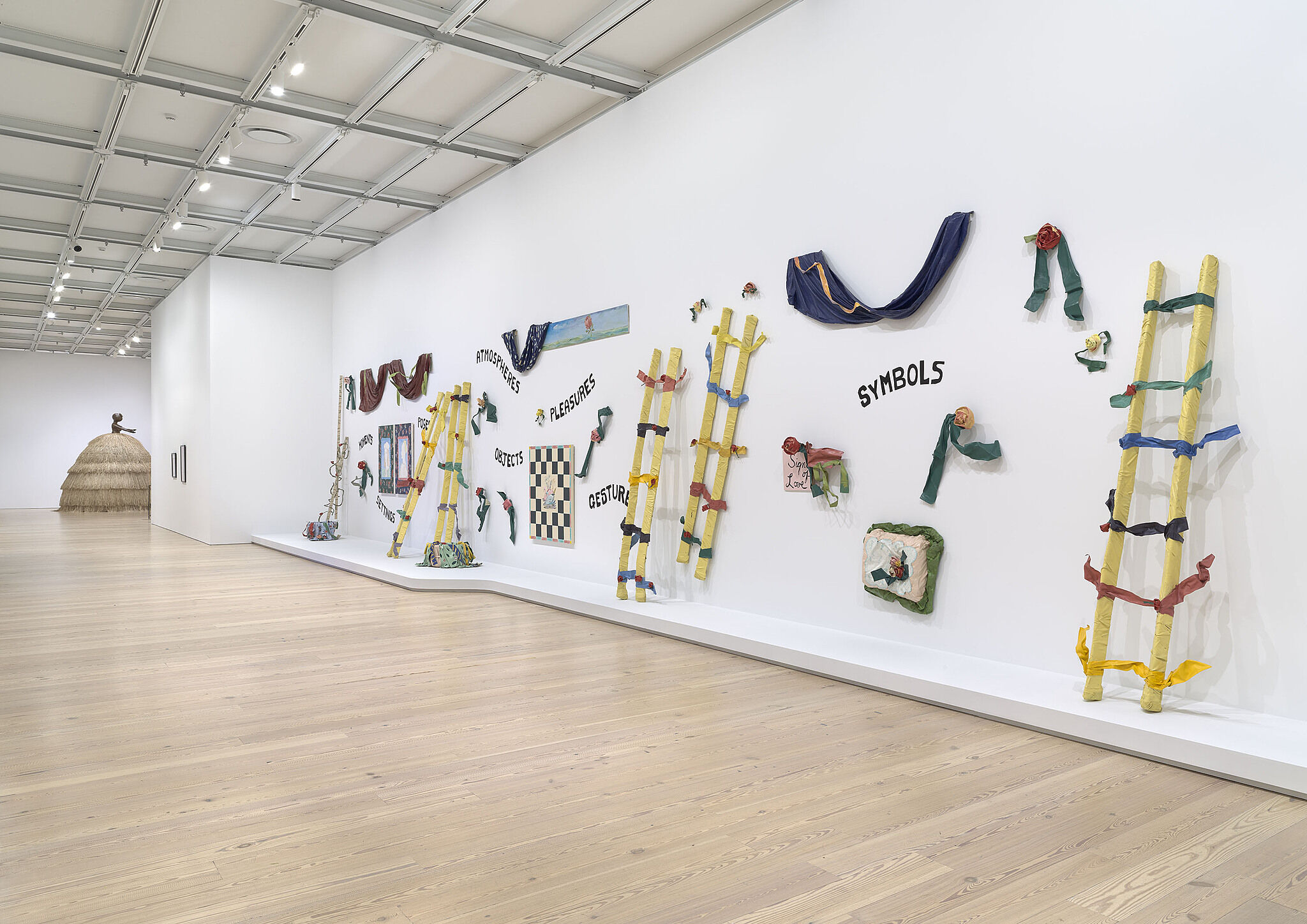 A photo of a Whitney gallery with various artworks.