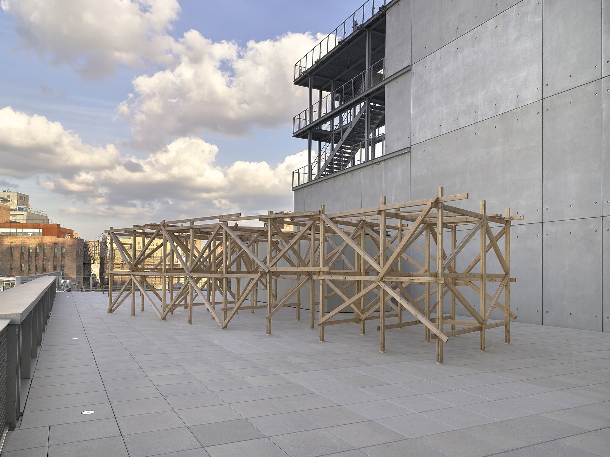 An outdoor wood and steel sculpture.