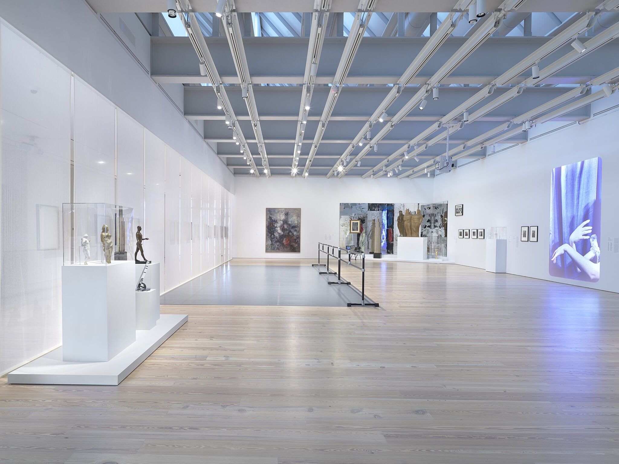 A photo of the Whitney galleries with various artworks.