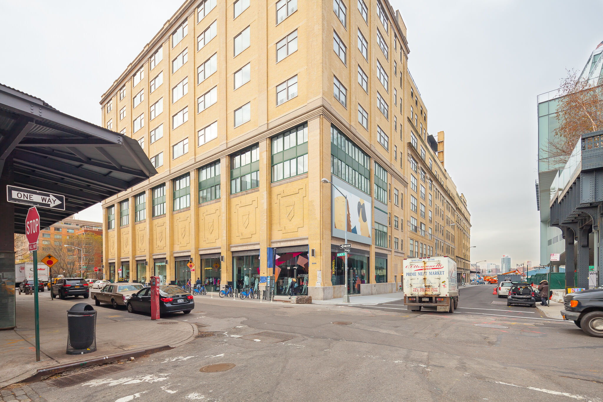 A New York City street corner with a billboard displayed on building.