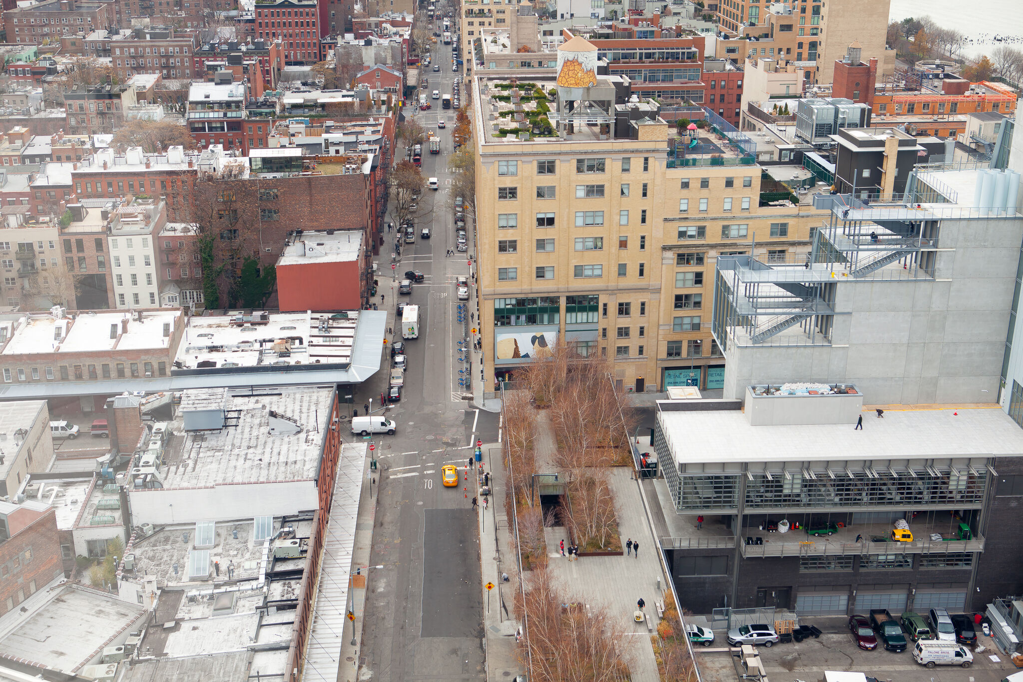 An aerial view of a New York City street with a billboard displayed on a building.