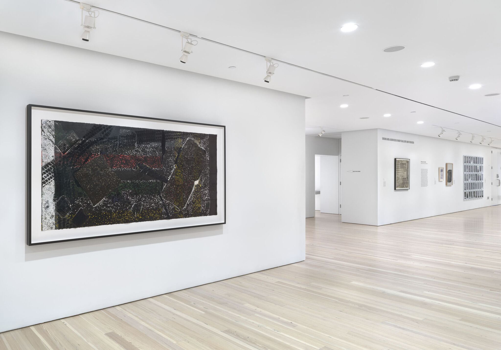 Works of art displayed on white walls in a gallery.