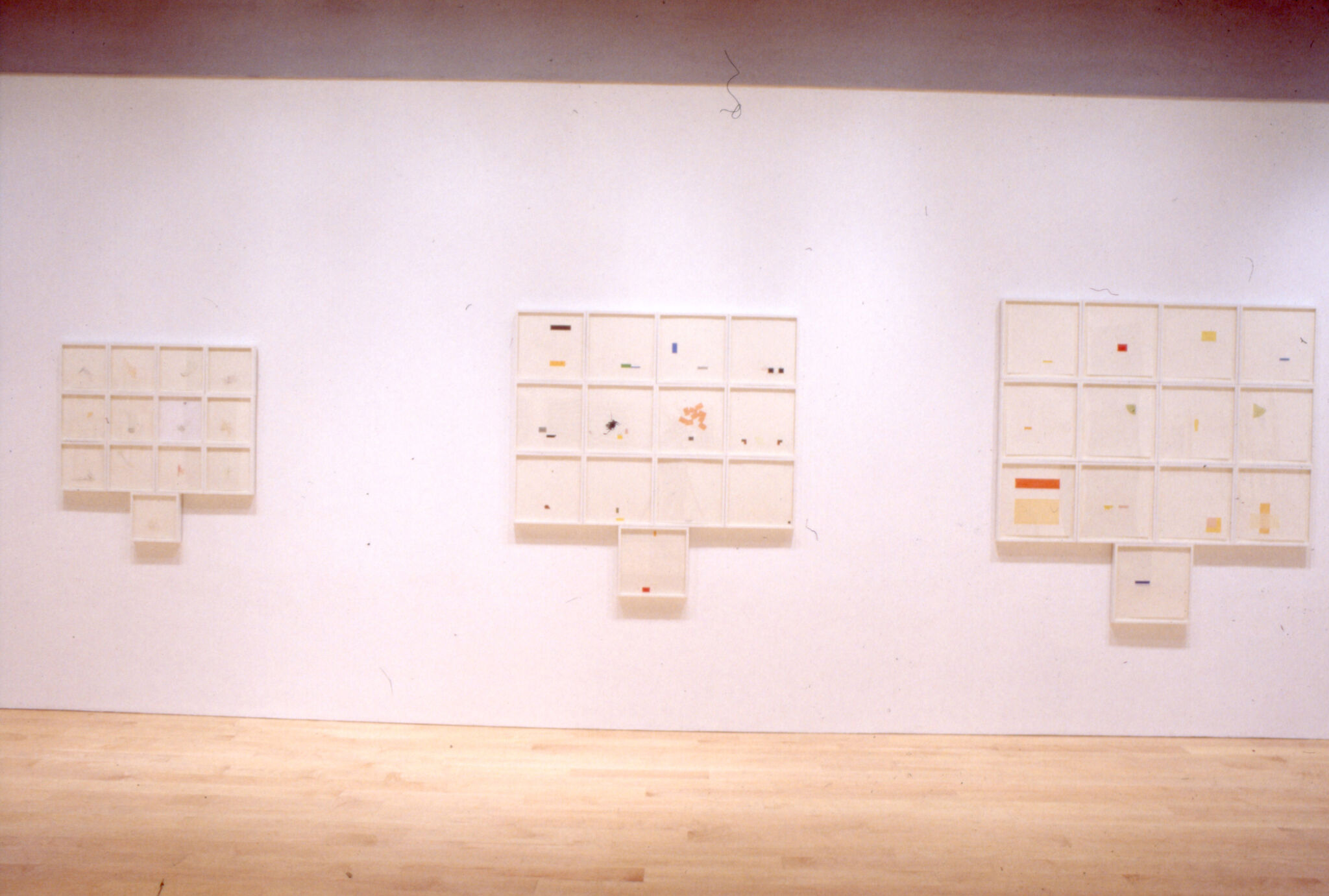 Prints displayed on a wall in a gallery.