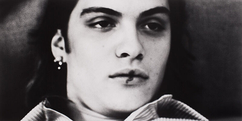 A close up of a face in a black and white photo.